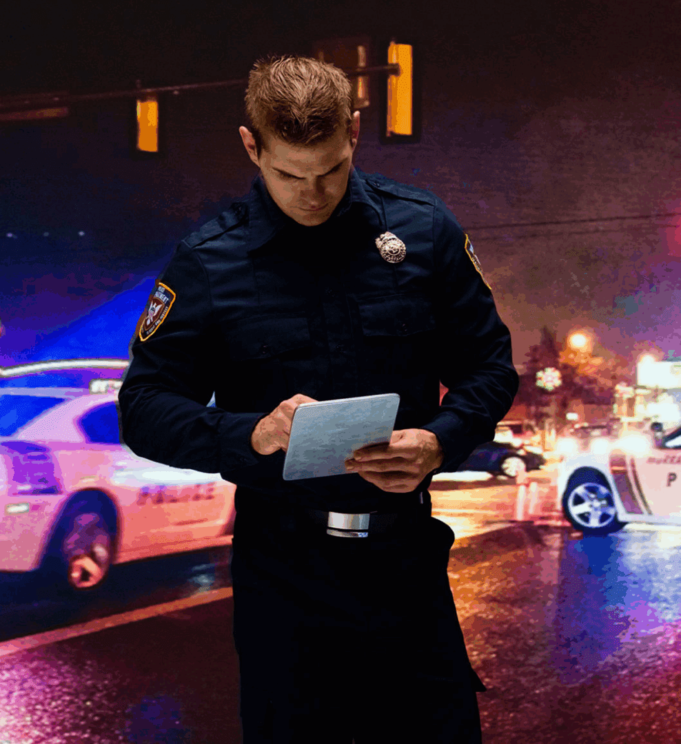 Police officer writing at night scene.